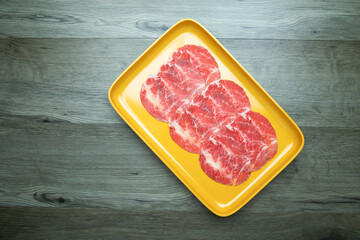 fresh raw pork, meat ,beef, belly, sliced on square plate  on wood, wooden background,set shabu, hot pot ingredients.