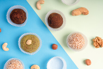 Flat lay of assortment of nut truffles or homemade organic sweet energy balls made of cashew,...