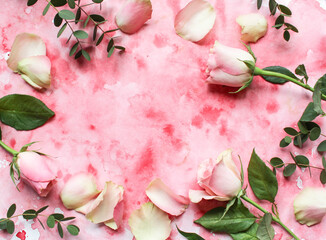 Floral frame made of rose flowers and petals on a pink background. Flat lay concept, top view.