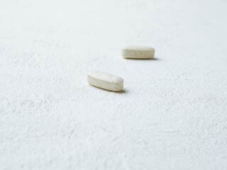 Fototapeta na wymiar Pills on white background. Vitamin and mineral tablet.