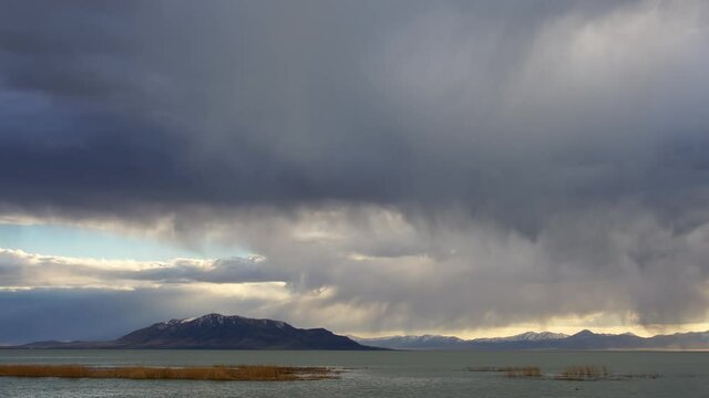 Storm clouds rolling through the sky over Utah Lake looking towards West Mountain.