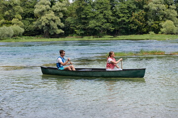 friends are canoeing in a wild river