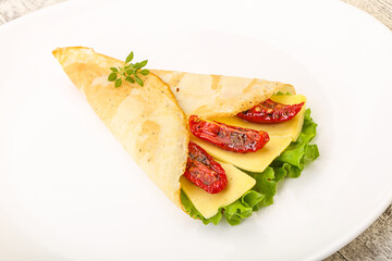 Pancake with cheese and dry tomato
