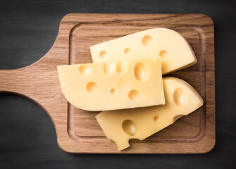 Fresh cheese on a wooden board. On black background.