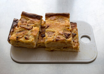 sliced apple pie on a plastic board, school catering concept, lunch for students