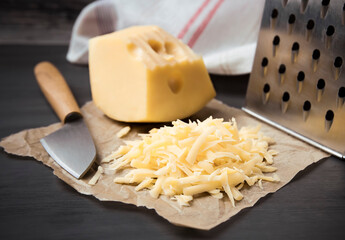 Fresh cheese on a parchment paper. On black background.