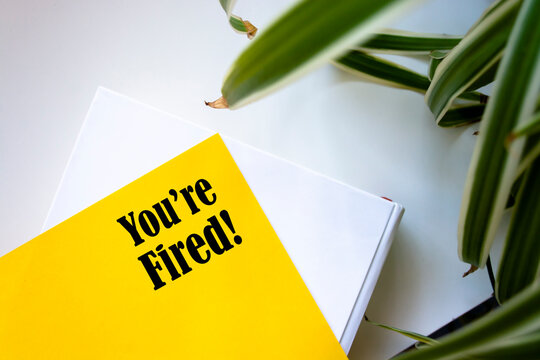 Hand writing text caption inspiration showing You Are Fired. Business concept for Unemployed or Discharge written sticky note paper