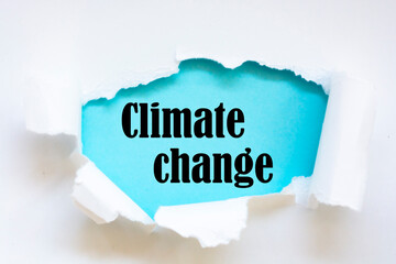 Torn paper revealing the word Climate change