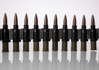 Machine gun tape with 7.62 caliber cartridges on a white isolated background