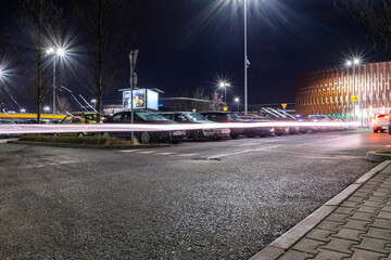 Parking lot cars. Car lot parking space in underground city garage. Empty road asphalt background. Industrial Shed or Parking Lot. © Maksym