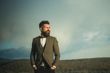 Hipster man with beard and mustache on unshaven face. Fashion businessman wear classic coat with...