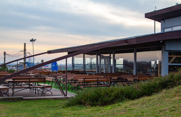 Obraz premium Ski resort not working. Warm winter. Global warming. Ski lifts. Green hills, no snow, no people.