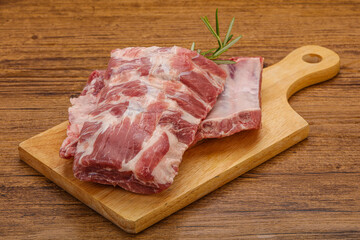 Raw pork ribs served rosemary