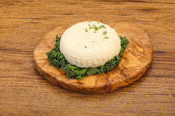 Caucasian suluguni round cheese piece