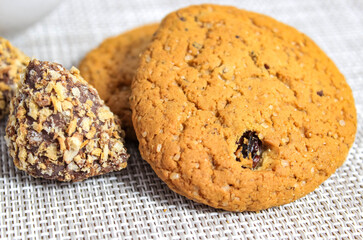 Oatmeal cookies with raisins and candy on the table close-up. Delicious desserts.