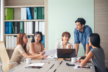 Happiness diversity business team meeting corporate office desk in company meeting room. Asian team group partner brainstorming discussion multiethnic people sitting share ideas teamwork in boardroom