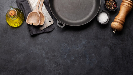 Frying pan, utensils and ingredients on kitchen table