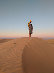 Fototapeta na wymiar Young man posing in the desert of Tunisia