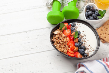 Healthy breakfast with bowl of granola, yogurt and fresh berries