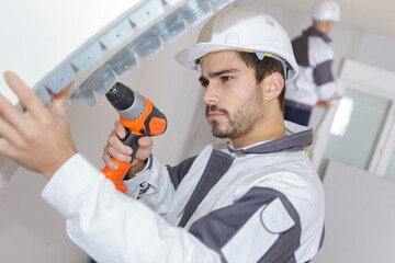 man working with drill indoors