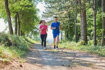 couple enjoying in a healthy lifestyle while jogging on a country road