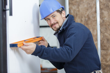 a happy man measures wall