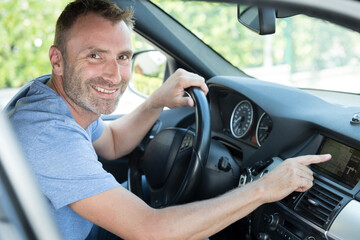man using gps navigation system in car