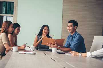 Fototapeta premium Happiness diversity business team meeting corporate office desk in company meeting room. Asian team group partner brainstorming discussion multiethnic people sitting share ideas teamwork in boardroom