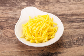 Shredded yellow cheese in the bowl