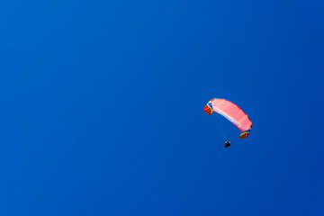 Paragliding extreme Sport with blue Sky and clouds on background Healthy Lifestyle and Freedom concept