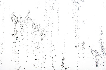 Fototapeta na wymiar Water Drops Background. Macro view of icy rain drops on the window creating abstract geometric graphic shapes. Close Up