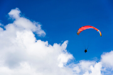 Paragliding extreme Sport with blue Sky and clouds in the background, Combining a Healthy Lifestyle...