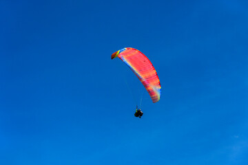 Paragliding extreme Sport with blue Sky and clouds on background Healthy Lifestyle and Freedom concept