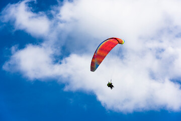 Paragliding extreme Sport with blue Sky and clouds on background Healthy Lifestyle and Freedom concept