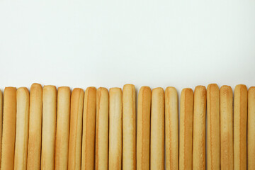Grissini breadsticks on white background, space for text