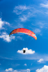 Paragliding extreme Sport with blue Sky and clouds on background Healthy Lifestyle and Freedom concept