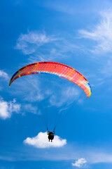 Paragliding extreme Sport with blue Sky and clouds on background Healthy Lifestyle and Freedom concept