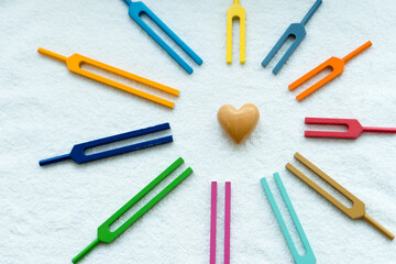 Set of tuning forks flatlay like symbol of sun with heart insideheart and sun and rainbow