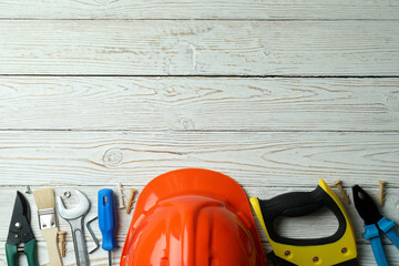 Concept of Labor Day with different construction tools on white wooden background
