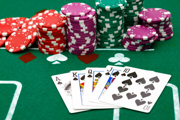 Playing cards and chips on green casino table background