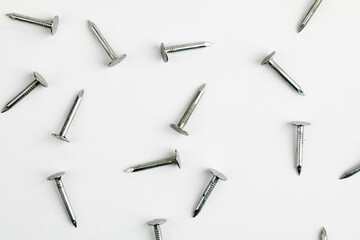 Metal nails close up, lots of nails on a white background.