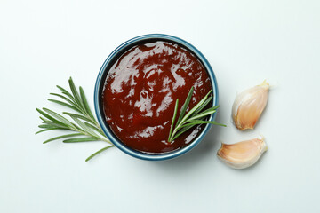 Barbecue sauce, rosemary and garlic on white background