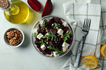Concept of tasty eating with beet salad on white textured background