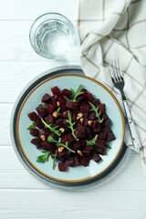 Concept of tasty eating with beet salad on wooden background