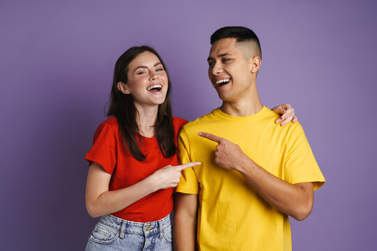 Brunette Joyful Couple Laughing And Pointing Finger At Themselves