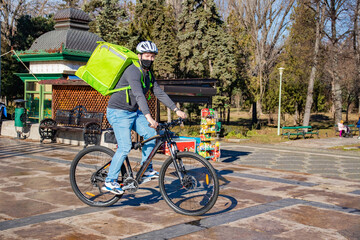 Delivery Man riding bike wearing mask