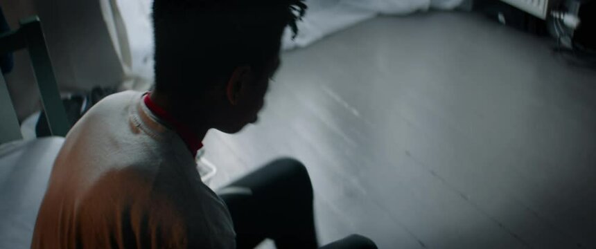 CU HANDHELD Portrait of African American Black kid teenager boy playing with basketball in his bedroom at home. Shot with 2x anamorphic lens