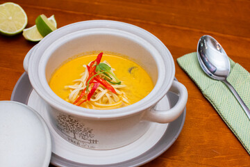 Tom Yam kung Spicy Thai soup with seafood, coconut milk and chili pepper 