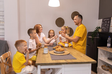 Happy young family having fun together on a Sunday morning having breakfast