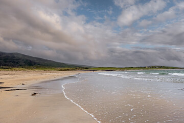 Sandy beach and ocean waves rushing towards the land. Irish nature landscape, Atlantic ocean,West...
